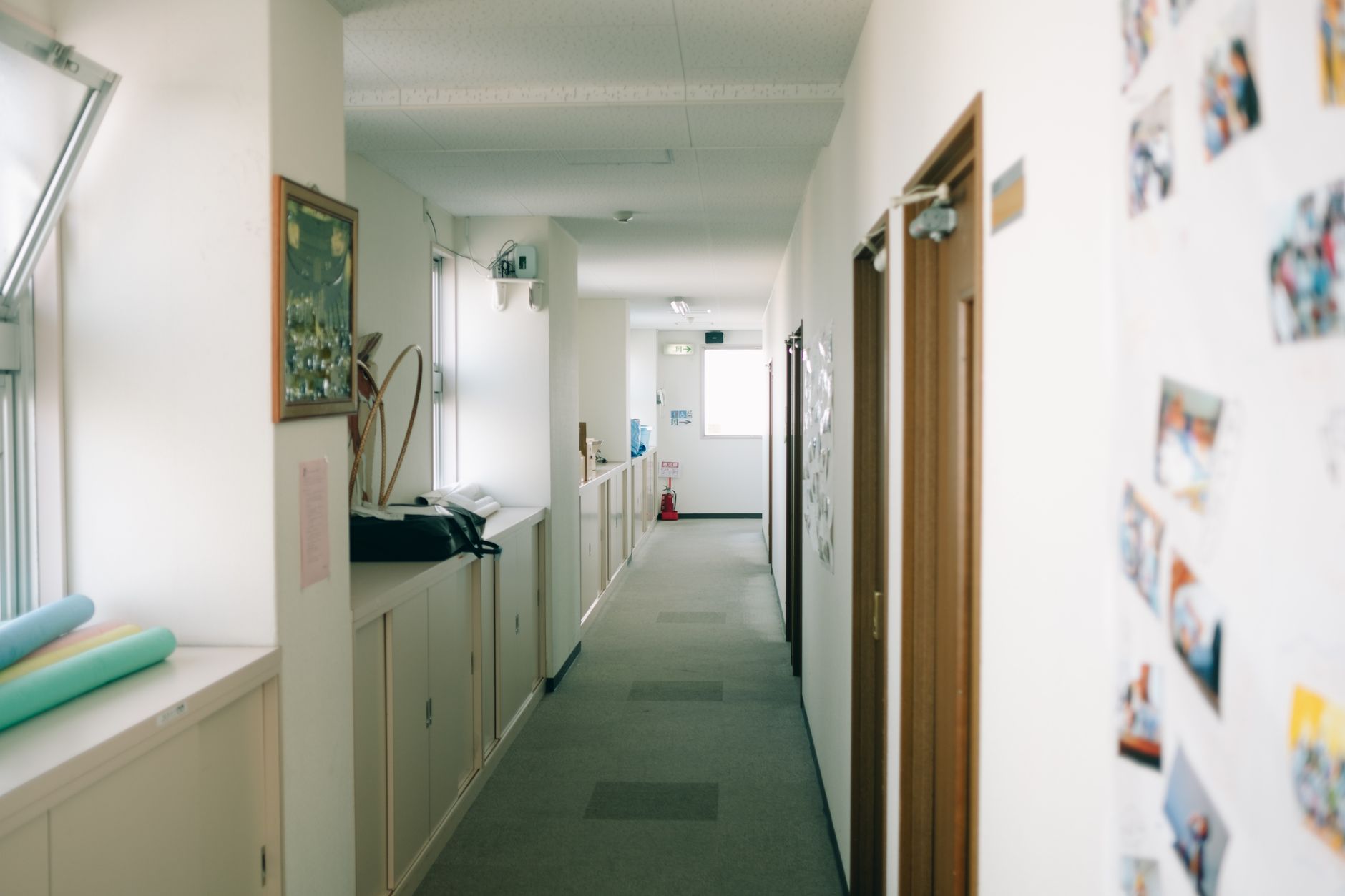 Spacious and well-lit indoor hallway featuring decor and open doors.