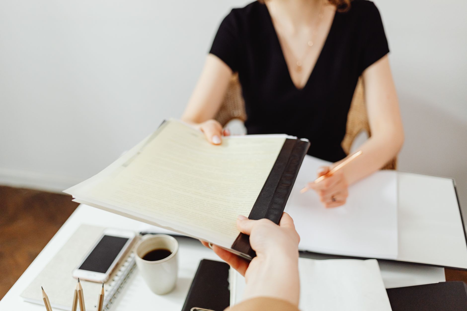 Close-up of a business document exchange at a desk